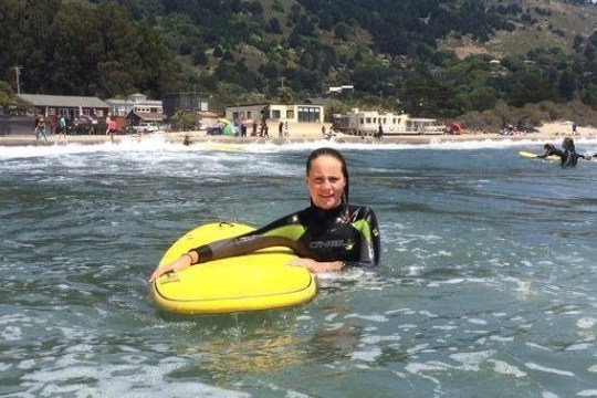 a person riding a surf board on a body of water